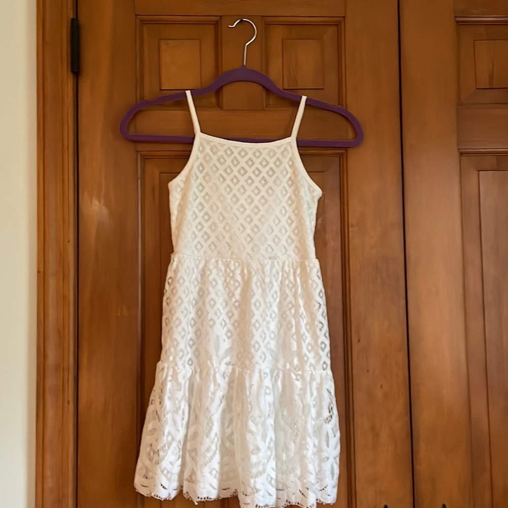 Beautiful white least dress with adjustable straps and zip up back
